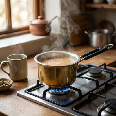 Brass saucepan on stovetop for traditional Indian cooking - heavy-gauge tin-lined cookware