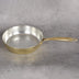 Brass skillet close-up showing tin lining and hand-hammered texture - non-toxic cookware