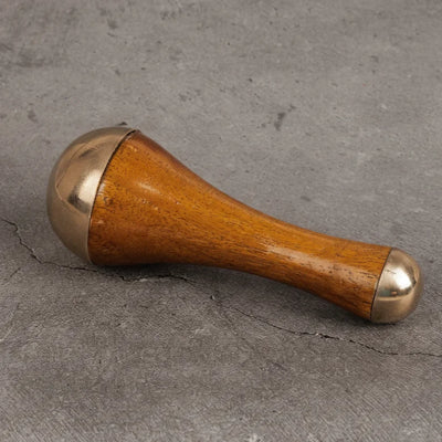 Face massage tool close-up - Kansa bronze wand for reducing puffiness and glow