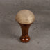 Kansa foot wand detail showing bronze dome - traditional Ayurvedic massage tool